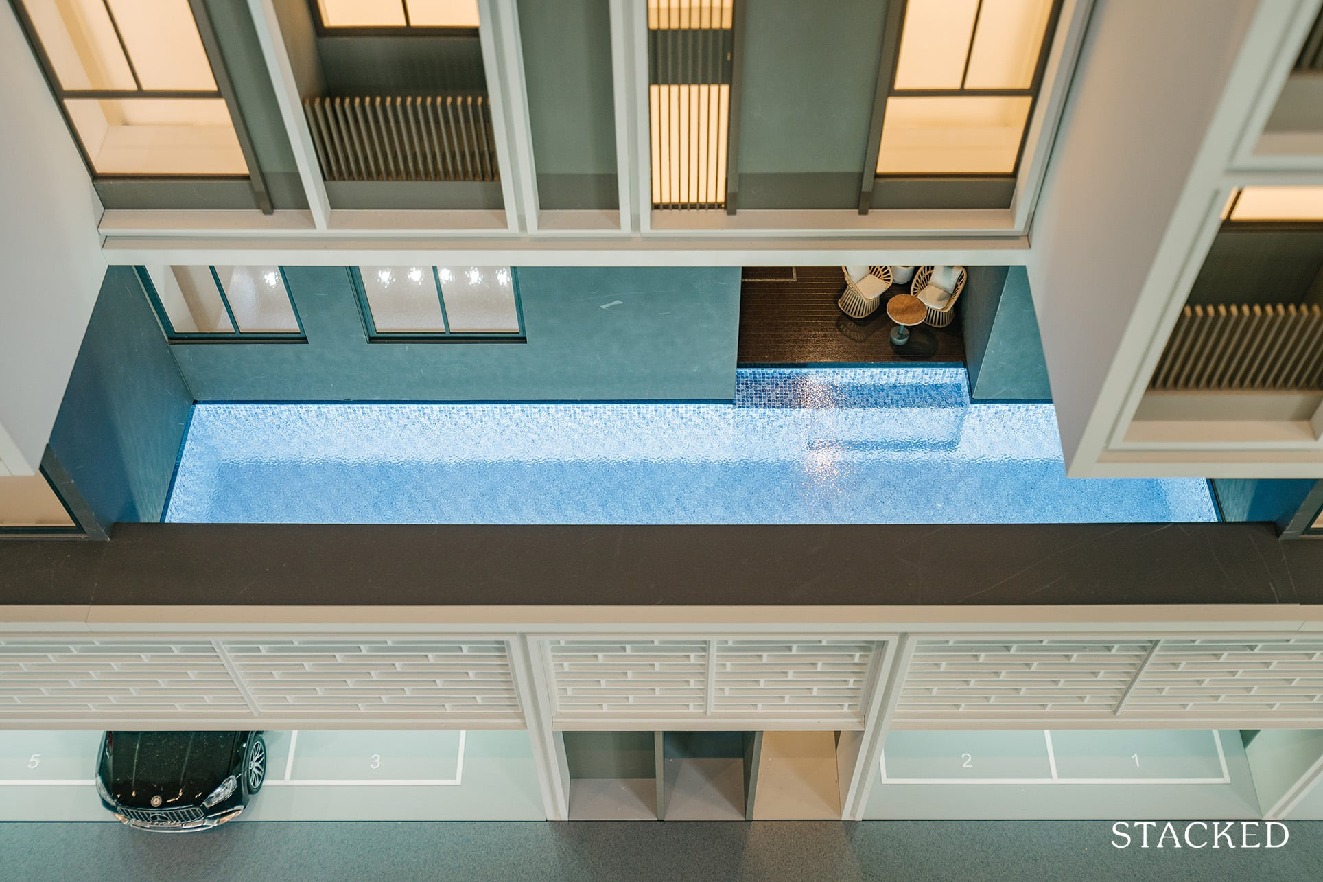 Swimming pool at Atlassia condominium with modern design and city views